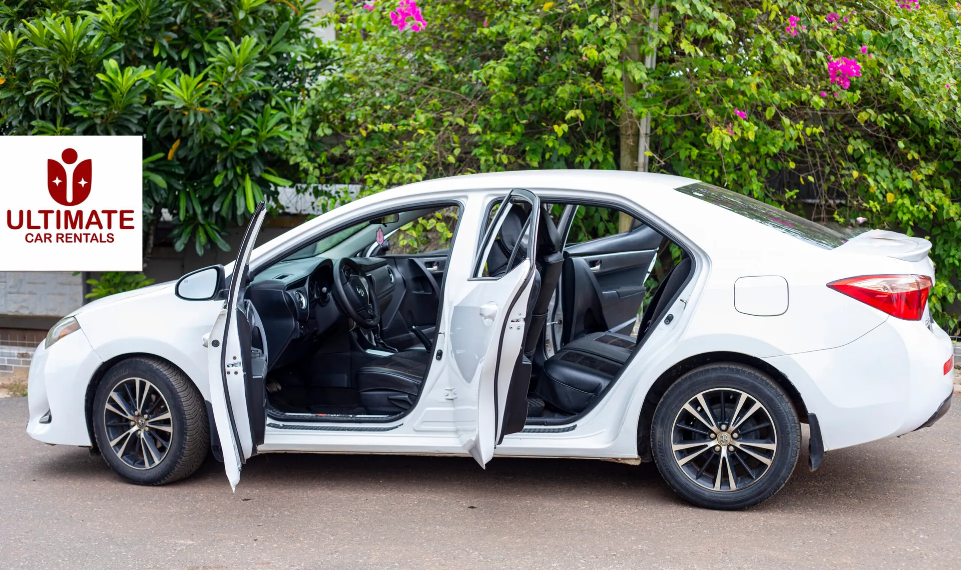 White Toyota Corolla with doors open